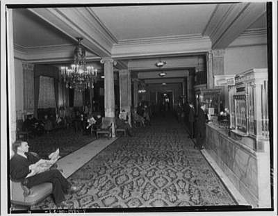 Lobby of Raleigh Hotel with man reading newspaper in foreground